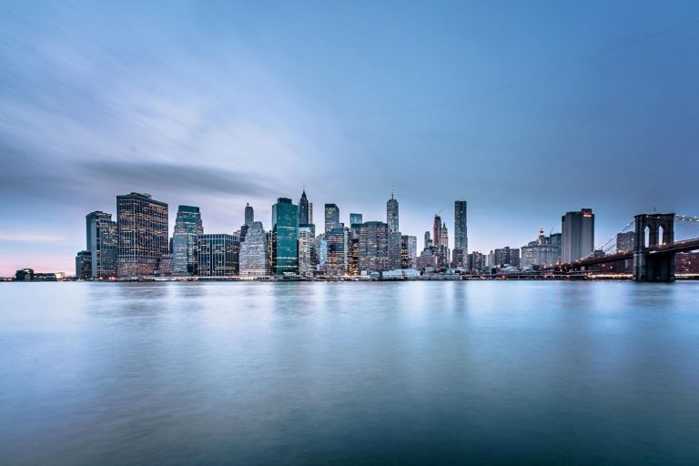 Eine nächtliche Panoramaaufnahme der Hochhäuser von Manhattan.
