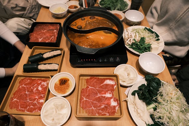 Eine vollständige Mahlzeit einschließlich Shabu Shabu, die auf einem Tisch angerichtet ist.