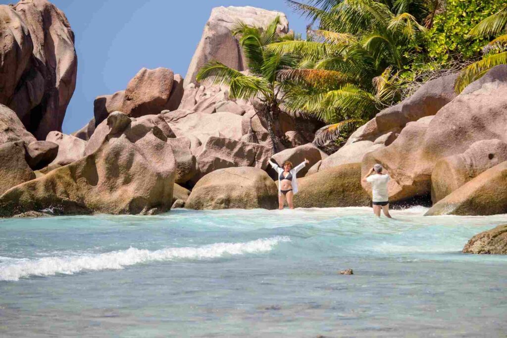 Una coppia che scatta foto su una spiaggia alle Seychelles