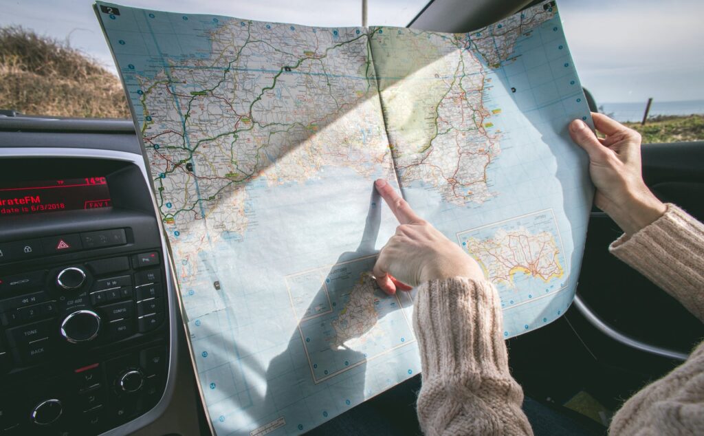 Following a paper map along travel route.