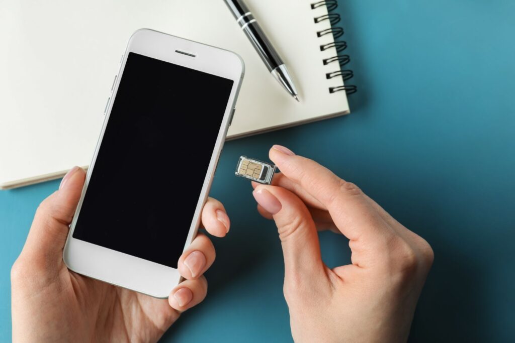 Woman putting a SIM card in her smarphone