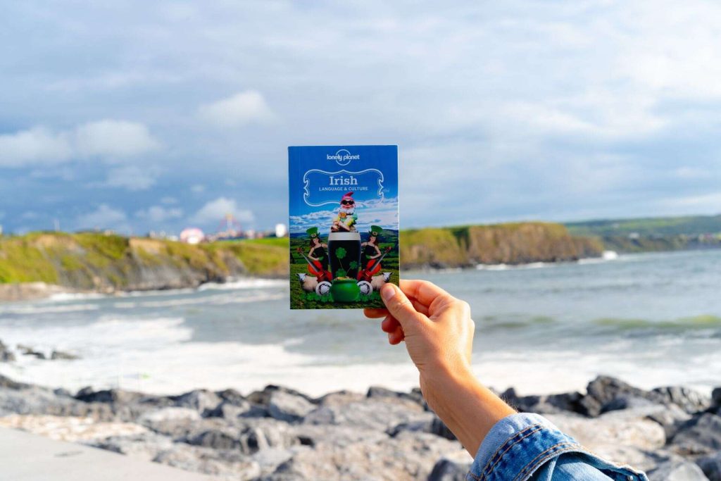 A hand holding an Irish language and culture card in Ireland