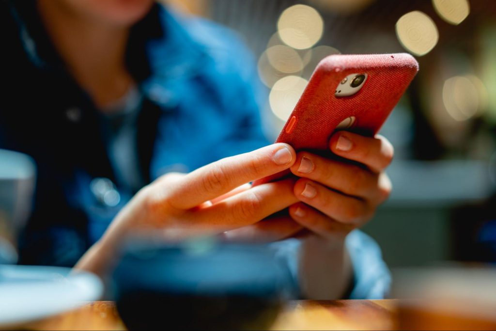 A woman handholding her smartphone 