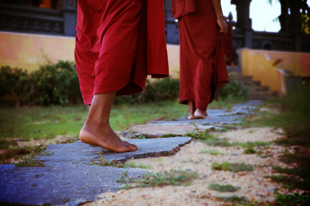 buddhist people walking with a monk dress